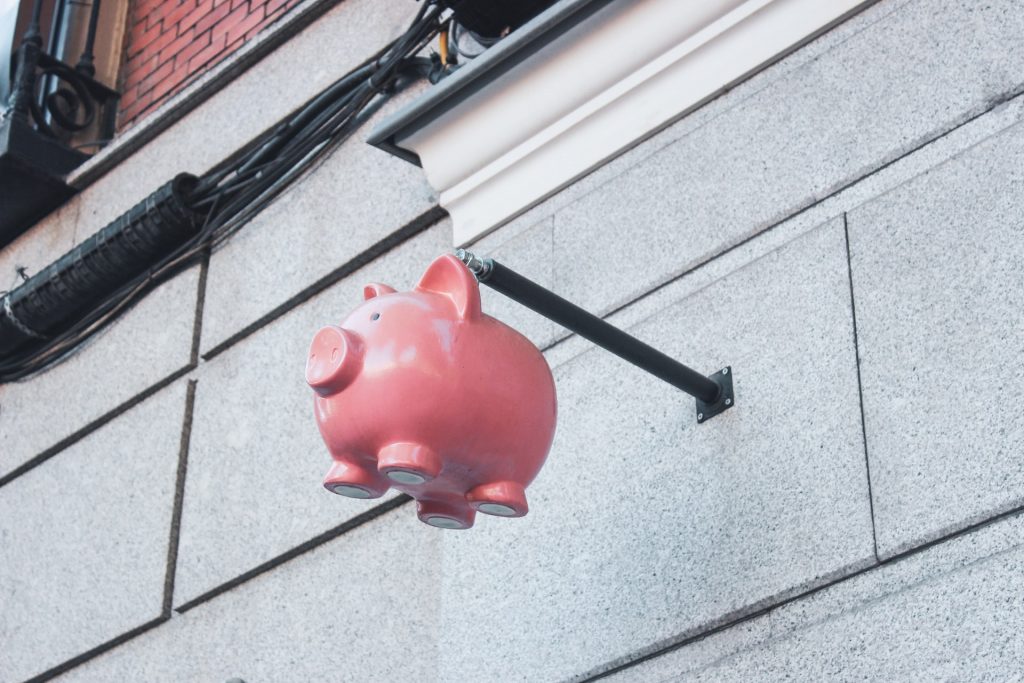 Piggy bank hanging outside a building