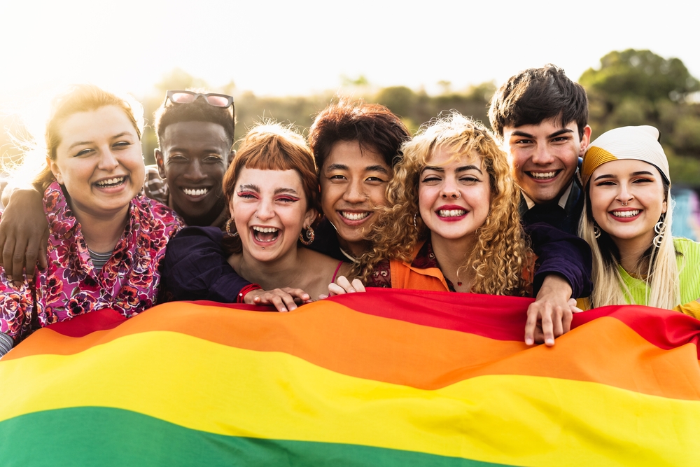 Group of people holding a rainbow flag